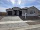 Charming single-story home with a three-car garage, block paved driveway and desert landscaping at 1191 E Ridgerock St, Casa Grande, AZ 85122