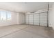 Spacious two-car garage with natural light from window and new concrete floor at 1191 E Ridgerock St, Casa Grande, AZ 85122