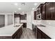 Sleek kitchen with stainless steel appliances, dark wood cabinets, quartz countertops and stylish flooring at 1191 E Ridgerock St, Casa Grande, AZ 85122