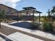 Community pavilion with picnic tables, a grill, and walkways amidst desert landscaping at 1191 E Ridgerock St, Casa Grande, AZ 85122