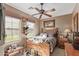 Comfortable bedroom with natural light, ceiling fan, and rustic Western decor at 12752 W Junipero Dr, Sun City West, AZ 85375