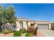 Charming single-story home showcasing desert landscaping, a tile roof, and a two-car garage at 12752 W Junipero Dr, Sun City West, AZ 85375