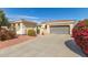 Attractive home with desert landscaping, showcasing a driveway leading to a garage at 12752 W Junipero Dr, Sun City West, AZ 85375