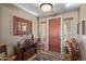 Inviting foyer with decorative mirror, console table, and rustic accents at 12752 W Junipero Dr, Sun City West, AZ 85375