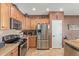 Well-equipped kitchen featuring stainless steel appliances, granite countertops, and ample cabinet space at 12752 W Junipero Dr, Sun City West, AZ 85375