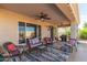 Inviting covered patio with comfortable seating, ceiling fans, and outdoor grill at 12752 W Junipero Dr, Sun City West, AZ 85375