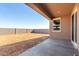 View of the large, unfinished backyard featuring a concrete patio and block wall at 13242 W Hackamore Dr, Peoria, AZ 85383