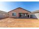 View of the large, unfinished backyard and covered patio, ready for landscaping at 13242 W Hackamore Dr, Peoria, AZ 85383