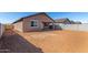 Wide angle view of the large, unfinished backyard with a covered patio and block wall at 13242 W Hackamore Dr, Peoria, AZ 85383