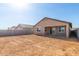 View of the large, unfinished backyard and covered patio, ready for your personal touch at 13242 W Hackamore Dr, Peoria, AZ 85383