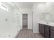 Bathroom featuring a glass shower enclosure and vanity with mirror at 13242 W Hackamore Dr, Peoria, AZ 85383