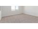 Bright, empty bedroom with carpet flooring and window at 13242 W Hackamore Dr, Peoria, AZ 85383