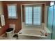 Bright bathroom with soaking tub, shower, and dual shuttered windows at 14009 N 30Th St, Phoenix, AZ 85032