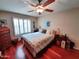 Bedroom with ceiling fan, shuttered windows, hardwood floors and dresser at 14009 N 30Th St, Phoenix, AZ 85032