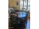 Elegant dining room with a wooden table, six upholstered chairs, and natural light filtering through the window at 14009 N 30Th St, Phoenix, AZ 85032