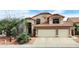 Charming two-story home with a red tile roof, a two-car garage, and beautiful desert landscaping at 14009 N 30Th St, Phoenix, AZ 85032