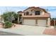 Charming two-story home with a red tile roof, a two-car garage, and desert landscaping at 14009 N 30Th St, Phoenix, AZ 85032