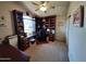 This home office features custom cabinets and plenty of natural light from the large window at 14009 N 30Th St, Phoenix, AZ 85032