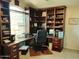 This home office features custom cabinets and plenty of natural light from the large window at 14009 N 30Th St, Phoenix, AZ 85032