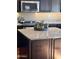 Modern kitchen featuring granite countertops, stainless steel appliances, and a central island with a dark wood finish at 14009 N 30Th St, Phoenix, AZ 85032