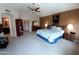 Large main bedroom with sitting area, ceiling fan, ensuite bathroom and carpet floors at 14009 N 30Th St, Phoenix, AZ 85032