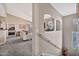 Hallway looking into living space with views into the dining area, neutral paint, and carpeted floors at 14250 W Wigwam Blvd # 1326, Litchfield Park, AZ 85340