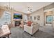 Inviting living room with a fireplace, antler chandelier, and gray carpet for a cozy atmosphere at 14250 W Wigwam Blvd # 1326, Litchfield Park, AZ 85340