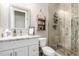 Modern bathroom featuring stone tile shower, decorative shelving, and granite vanity at 1444 W Gail Rd, San Tan Valley, AZ 85144