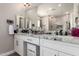 Modern bathroom with double sinks, granite countertops, and stylish white cabinets at 1444 W Gail Rd, San Tan Valley, AZ 85144