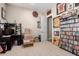 Neutral bedroom with a doorway, sports memorabilia decor, and shelf filled with movies and games at 1444 W Gail Rd, San Tan Valley, AZ 85144