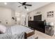 Bright bedroom with a large dresser, ceiling fan, and a doorway leading to the bathroom at 1444 W Gail Rd, San Tan Valley, AZ 85144