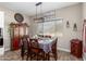 Charming dining area with natural light, stylish decor, and views of the desert landscape outside at 1444 W Gail Rd, San Tan Valley, AZ 85144