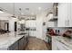 Modern kitchen with a large island, stainless steel sink, and bright white cabinets for a clean, elegant look at 1444 W Gail Rd, San Tan Valley, AZ 85144