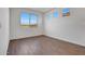 Bright bedroom featuring wood-look flooring, a large window, and white walls at 14782 W El Cortez Pl, Surprise, AZ 85387