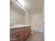 Bathroom featuring double sinks, wood cabinets and shower over tub at 15232 W Edgemont Ave, Goodyear, AZ 85395