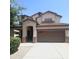 Two-story home showcasing a brown garage door, neutral stucco exterior and manicured landscaping at 15232 W Edgemont Ave, Goodyear, AZ 85395