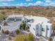 Modern home with a multi-car garage and desert landscaping set in a desert community at 15642 E Palatial Dr, Fountain Hills, AZ 85268