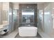 Bathroom featuring a soaking tub, dual showers, and marble tile at 15642 E Palatial Dr, Fountain Hills, AZ 85268