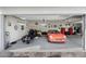 View of an organized garage with epoxy floors, featuring a motorcycle and an orange sports car at 15642 E Palatial Dr, Fountain Hills, AZ 85268