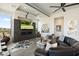 Modern living room with a sleek black fireplace, TV, and unique decorative touches at 15642 E Palatial Dr, Fountain Hills, AZ 85268