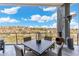 Outdoor patio area with a table setting and stunning desert views under a bright, cloudy sky at 15642 E Palatial Dr, Fountain Hills, AZ 85268