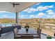 Outdoor patio area with dining table, lounge seating, and panoramic views of the desert landscape at 15642 E Palatial Dr, Fountain Hills, AZ 85268