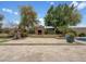 Beautiful backyard with a stone fireplace, waterfall feature, and lush landscaping at 15829 W Bonitos Dr, Goodyear, AZ 85395