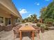 Inviting backyard patio with an outdoor dining area and views of the landscaped yard at 15829 W Bonitos Dr, Goodyear, AZ 85395