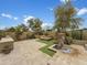 Beautiful outdoor space featuring a built-in grill, stone fountain and waterfall with lush landscaping at 15829 W Bonitos Dr, Goodyear, AZ 85395