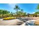 Community entry featuring palm trees, landscaped area, and gated entrance at 15829 W Bonitos Dr, Goodyear, AZ 85395