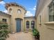 Inviting home exterior showcasing a unique turret-style entrance, desert landscaping, and a blue front door at 15829 W Bonitos Dr, Goodyear, AZ 85395