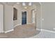 Elegant foyer featuring arched entryways, a stylish light fixture, and a dark-blue front door at 15829 W Bonitos Dr, Goodyear, AZ 85395