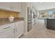 Modern kitchen featuring white cabinets, stainless steel appliances, and granite countertops and tile flooring at 15829 W Bonitos Dr, Goodyear, AZ 85395