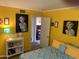 Stylishly decorated bedroom with bright yellow walls, unique art, and modern furnishings at 17429 E La Pasada Dr, Fountain Hills, AZ 85268